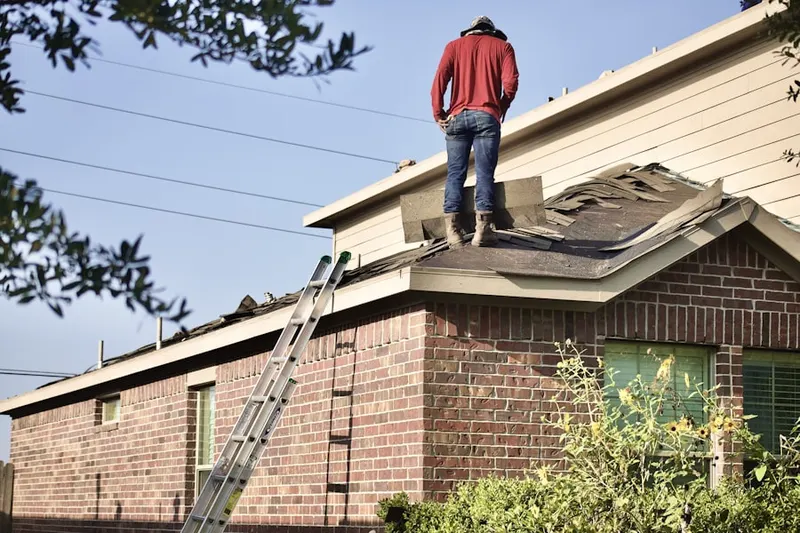 Professional roofer working on a residential roof in Carrboro